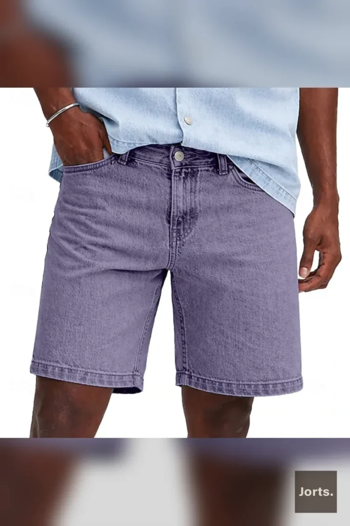 Mens loose fit cropped denim shorts in blue, front view.